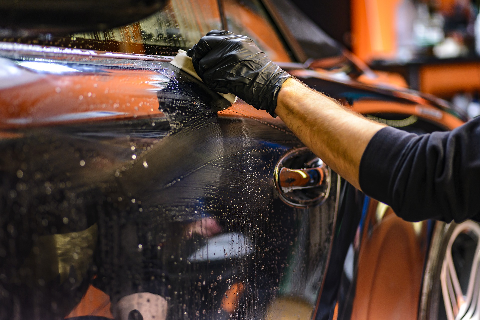 Washing a car by hand.