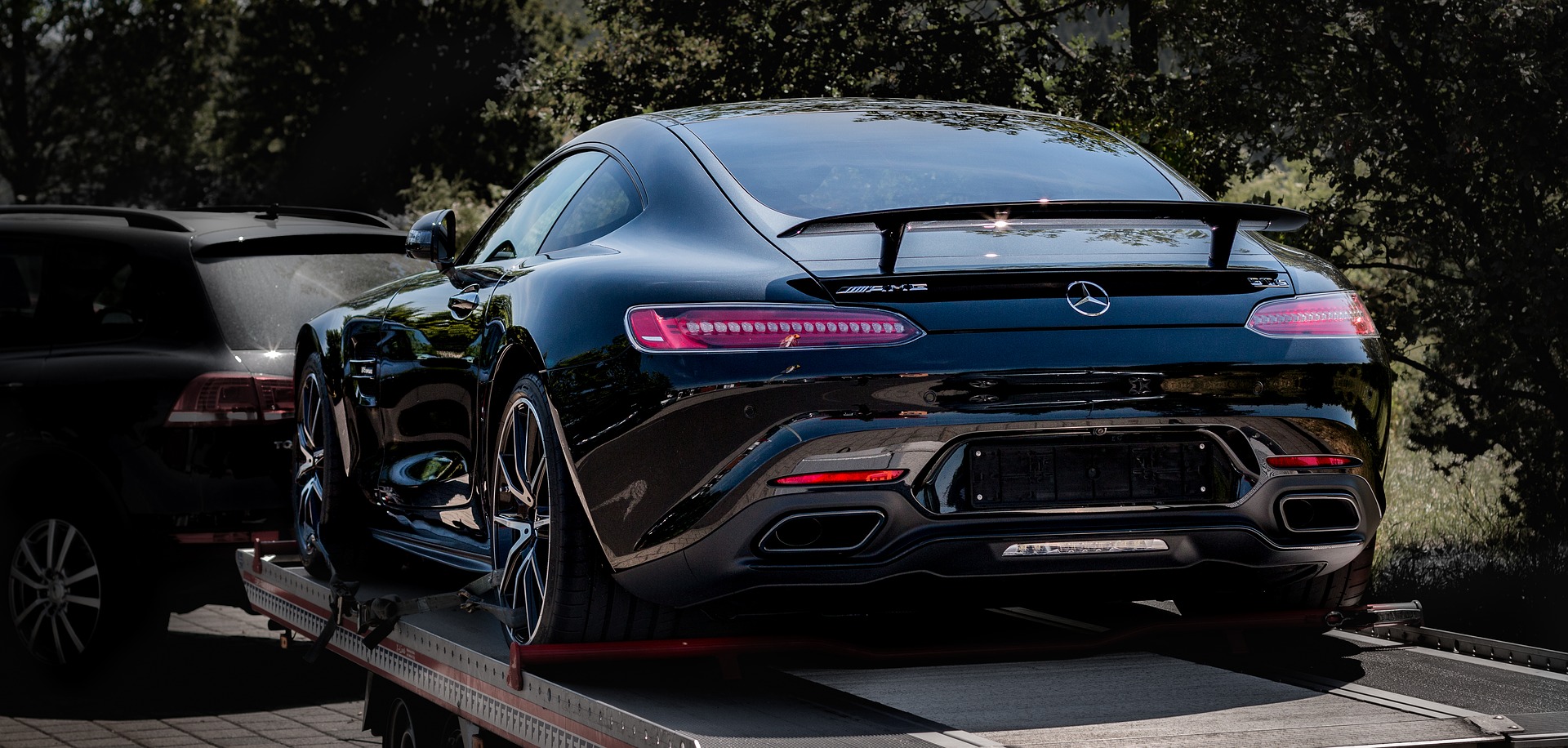 Mercedes-Benz towed by SUV.